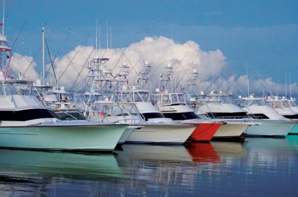 multi color sportfishing boat hulls reflecting on the water