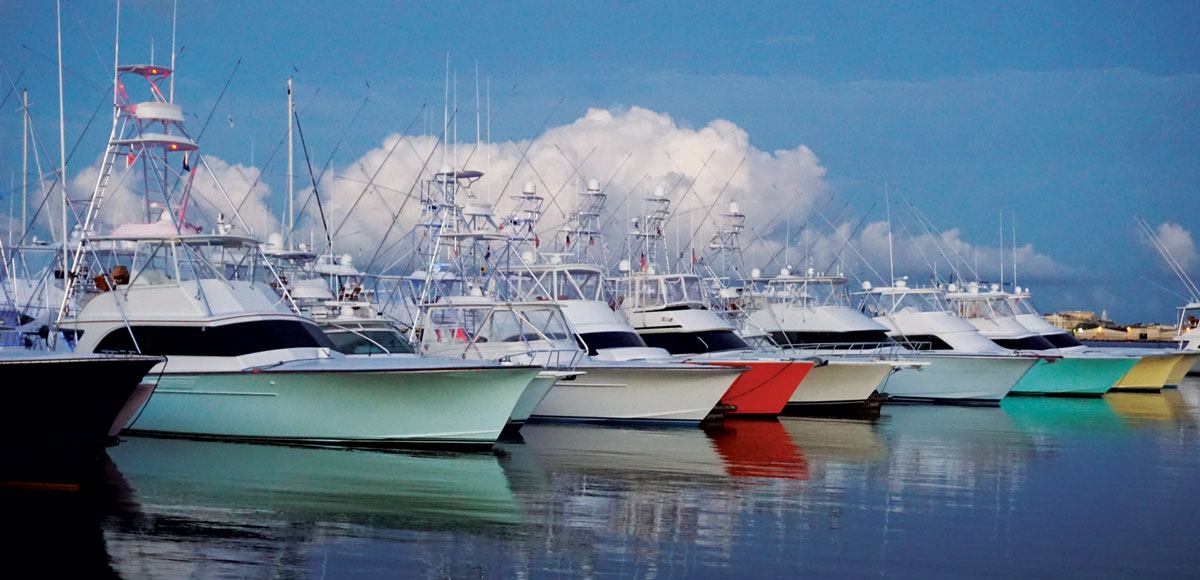 multi color sportfishing boat hulls reflecting on the water