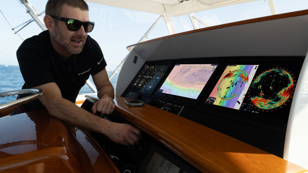 a guy looking at marina electronics on the boat